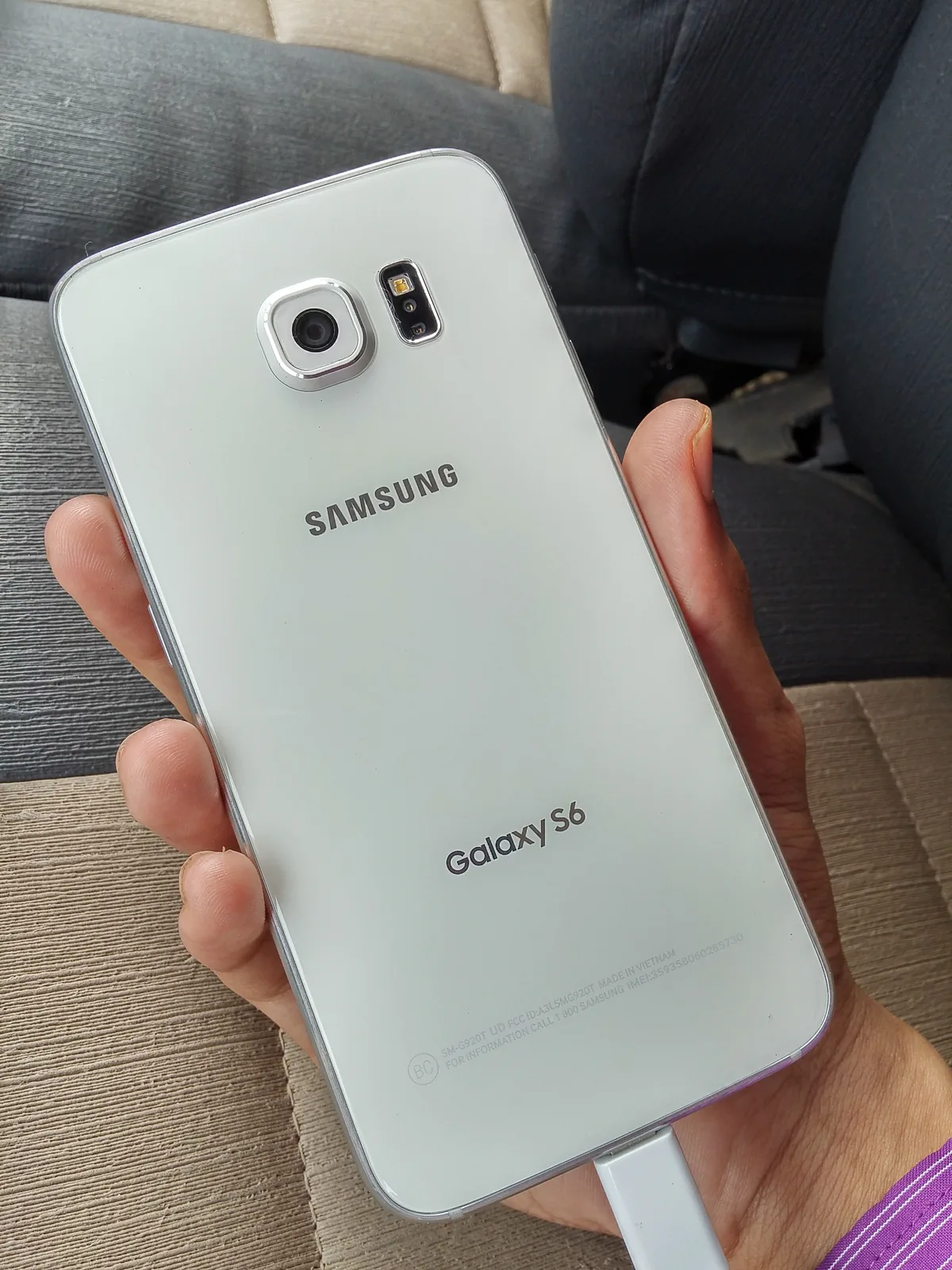 Samsung Galaxy S6 white handset rear, camera and heart-rate sensor area, original framing retained