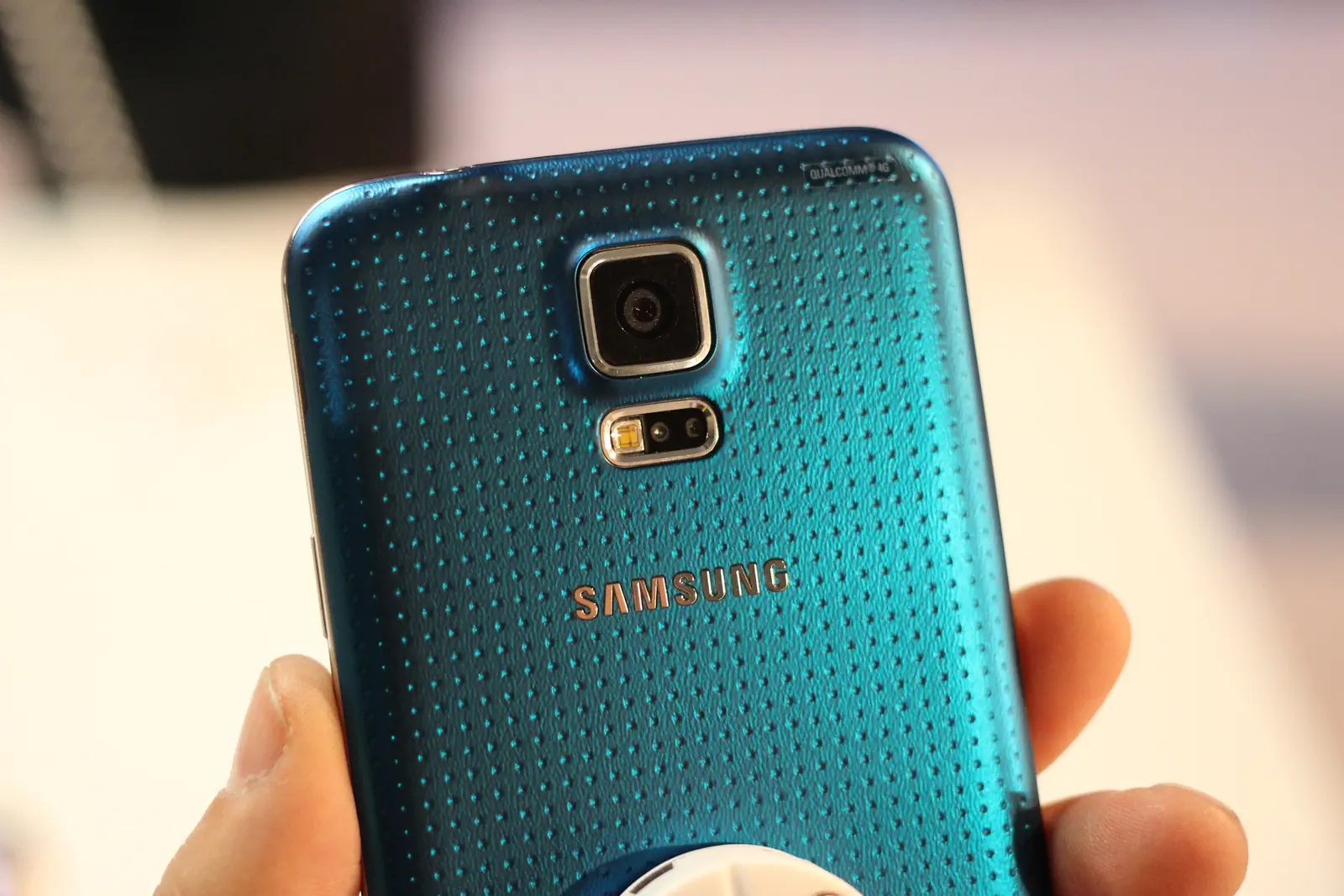 Samsung Galaxy S5 blue rear close-up with camera and heart-rate sensor area at MWC 2014