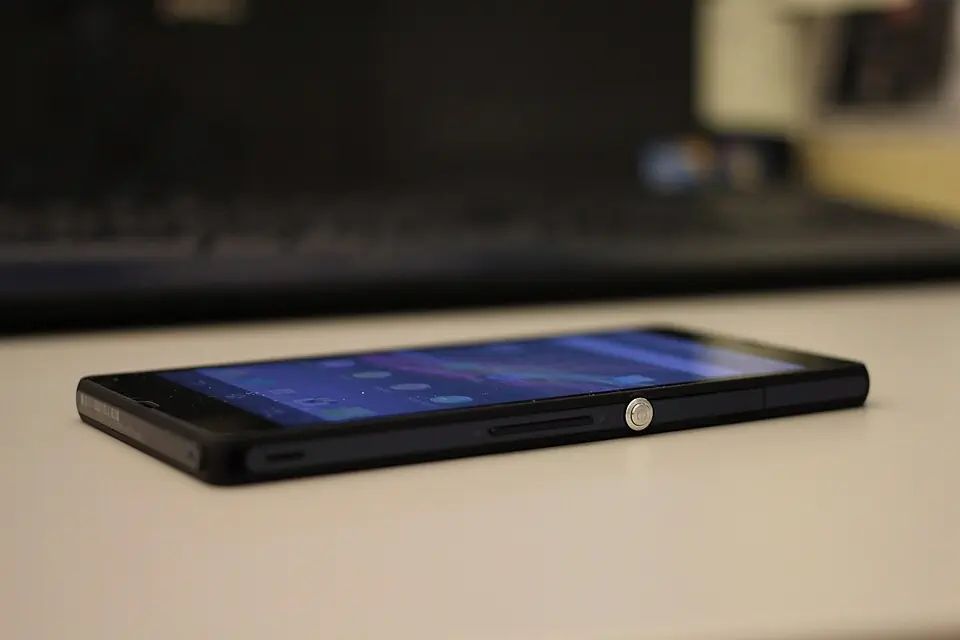 Low-angle Xperia Z side view showing the flat body and round power key